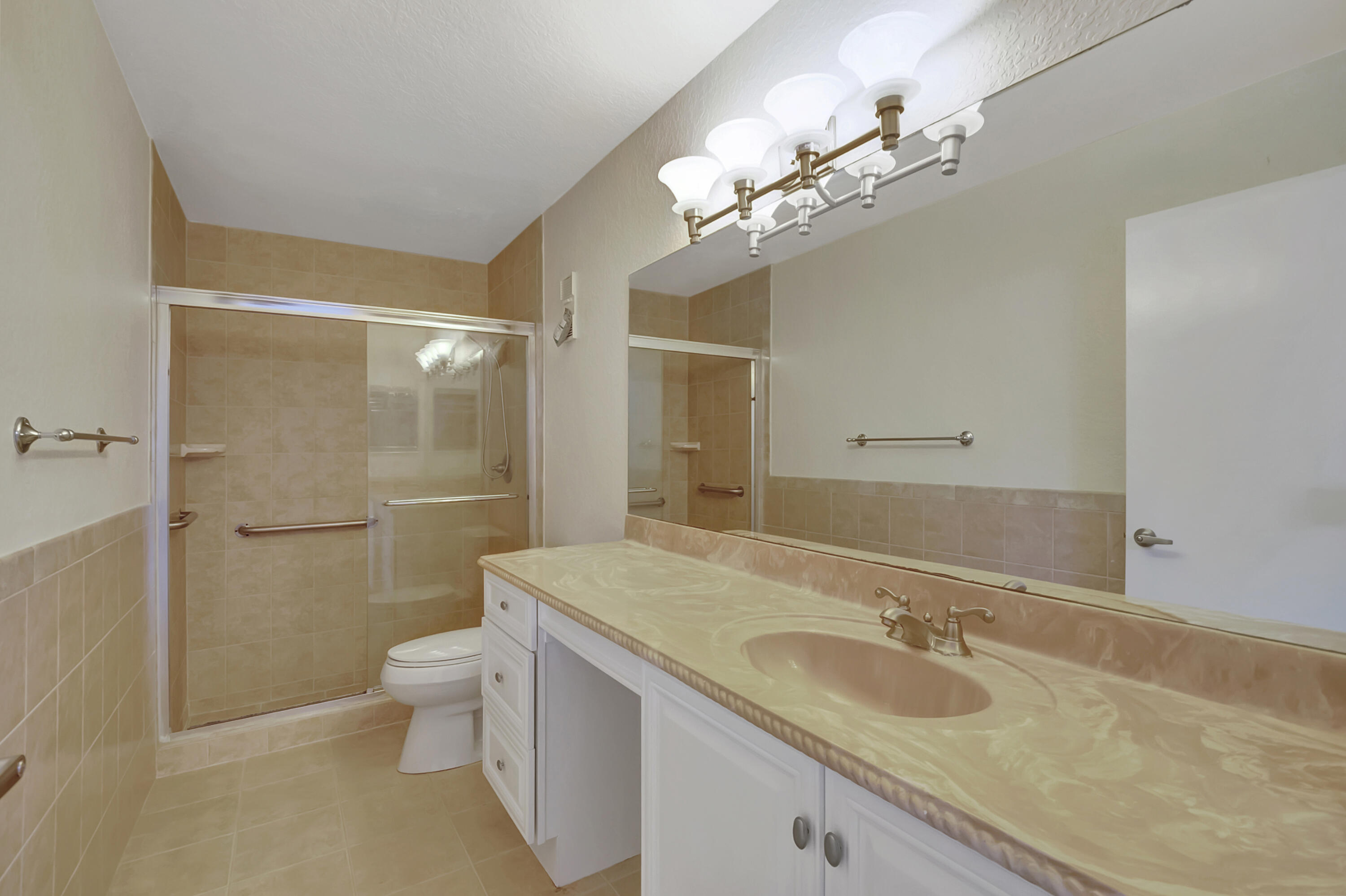 18559 Breezy Palm Way Boca Raton, FL 33496 - Photo 23 of 43 a bathroom with a granite countertop sink a toilet and shower