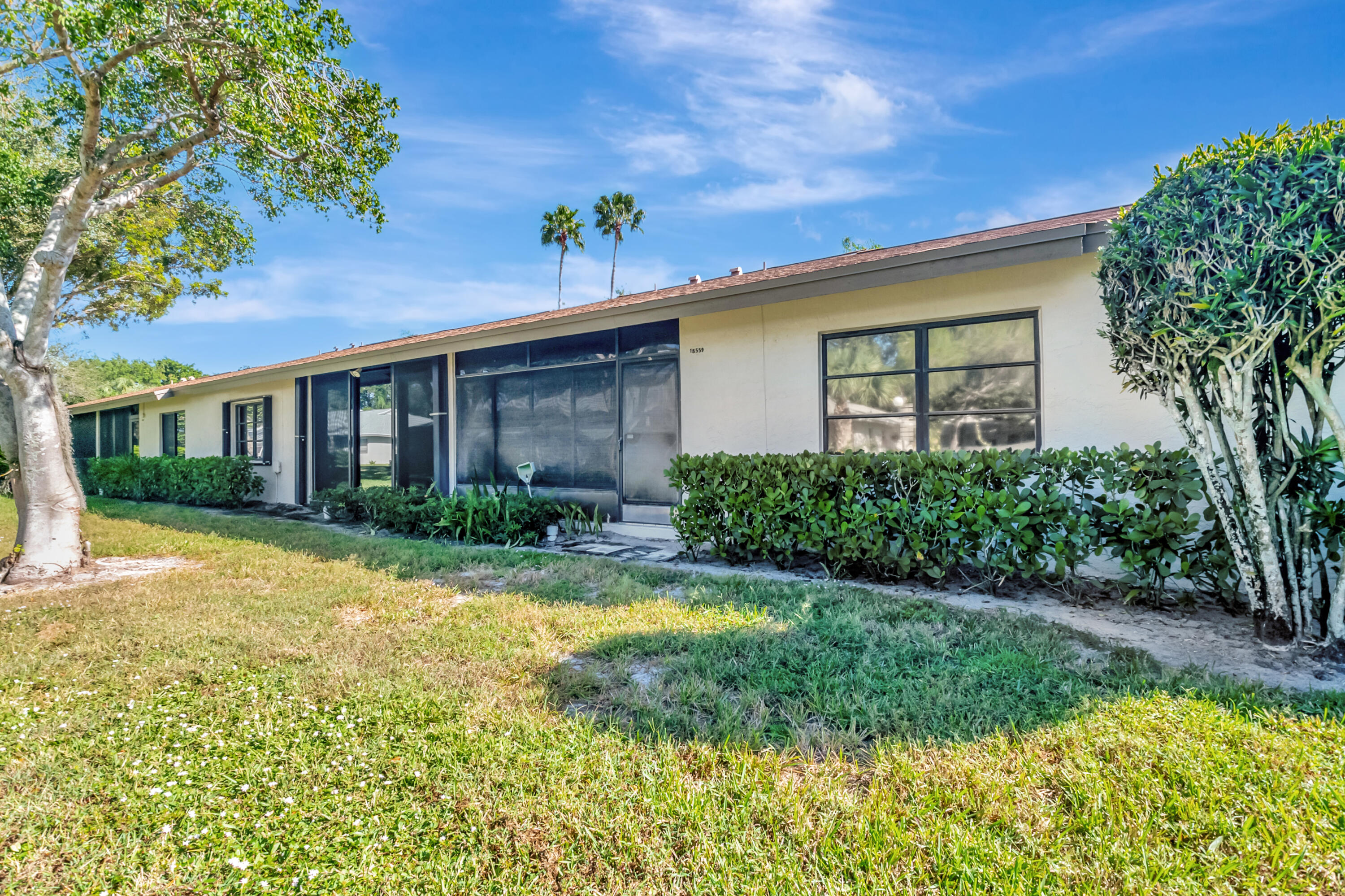 18559 Breezy Palm Way Boca Raton, FL 33496 - Photo 32 of 43 a front view of a house with a yard