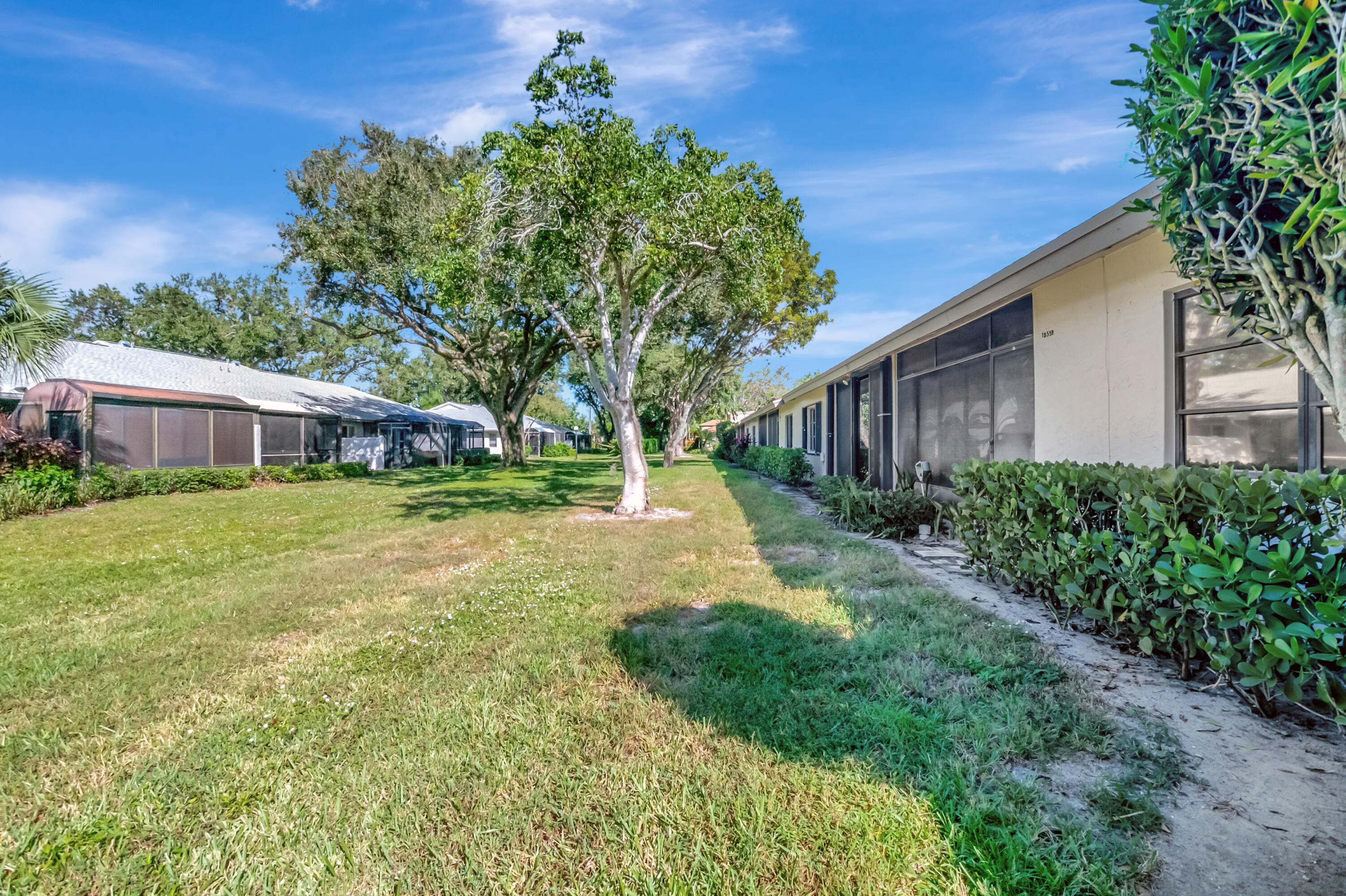 18559 Breezy Palm Way Boca Raton, FL 33496 - Photo 33 of 43 a view of a house with backyard and a tree