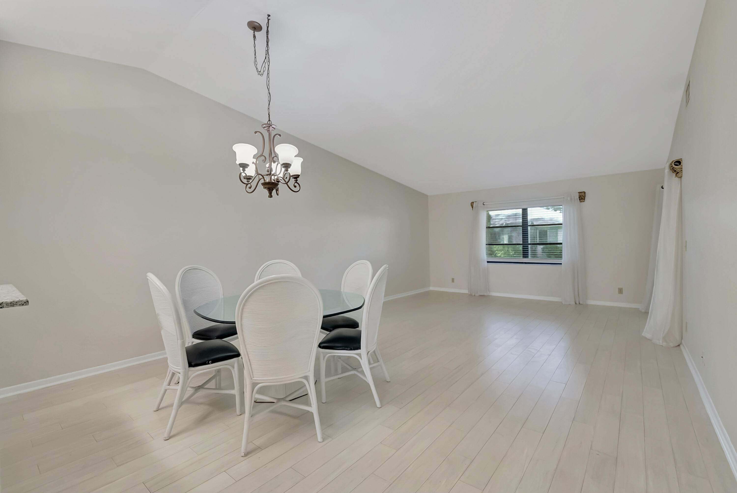 18559 Breezy Palm Way Boca Raton, FL 33496 - Photo 6 of 43 a dining room with furniture a chandelier and wooden floor