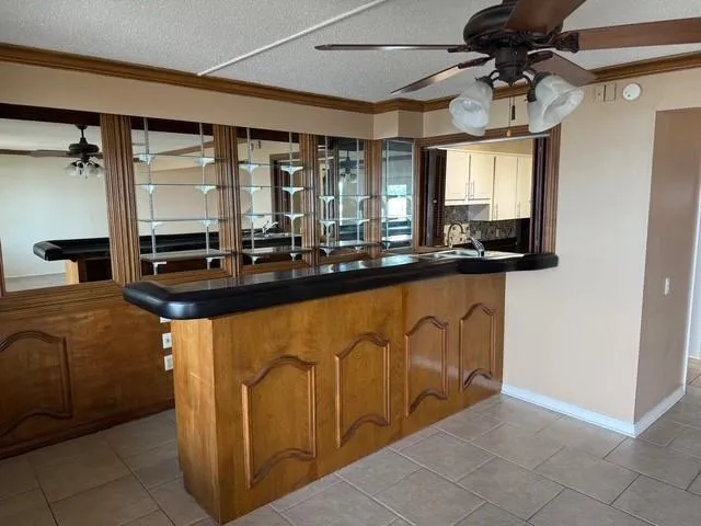 a kitchen with stainless steel appliances granite countertop a sink and a refrigerator