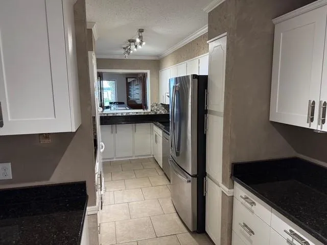 a kitchen with a refrigerator and a sink