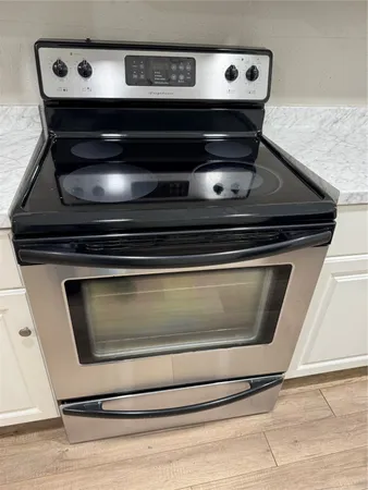 a stove top oven sitting inside of a kitchen
