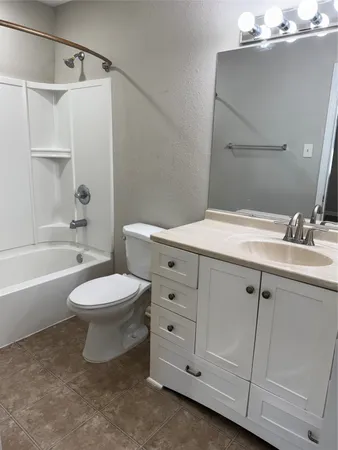 a bathroom with a sink a toilet and bathtub