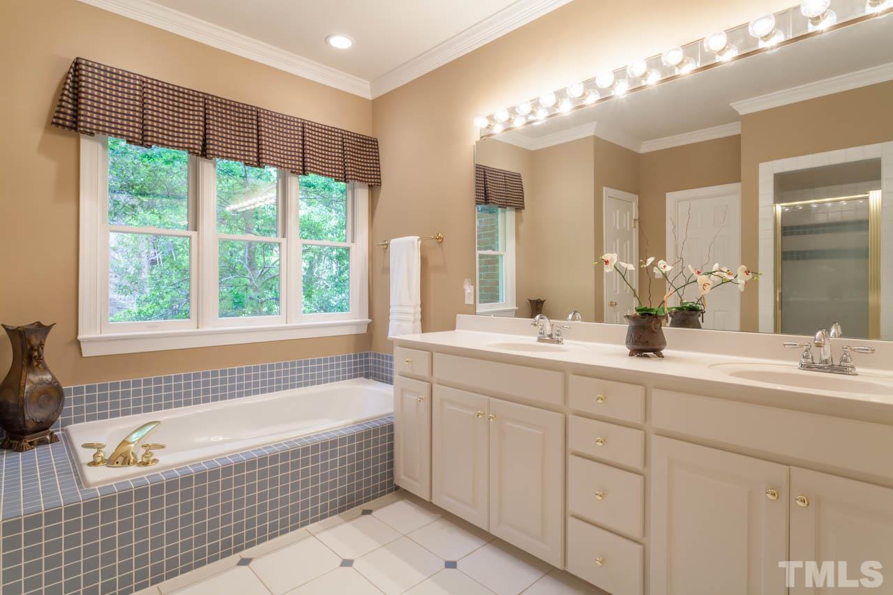 13921 Possum Track Road Raleigh, NC 27614 - Photo 19 of 25 Dual vanity and soaking tub with large window for that beautiful natural light!