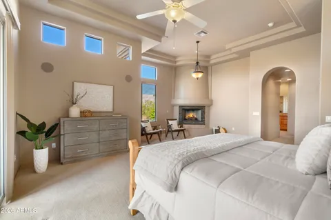 a bedroom with a bed and ceiling fan