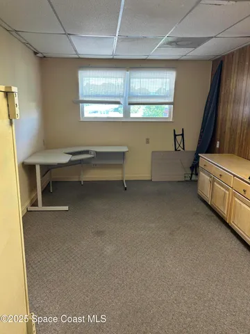 a view of a room with window and furniture