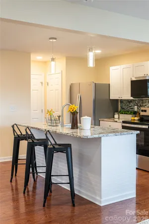 a kitchen with a table chairs and a view of living room