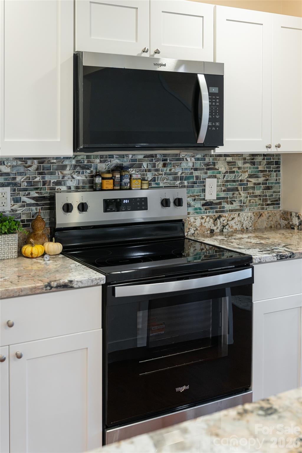 622 North Main Street Canton, NC 28716 - Photo 14 of 36 a kitchen with granite countertop a stove and a microwave