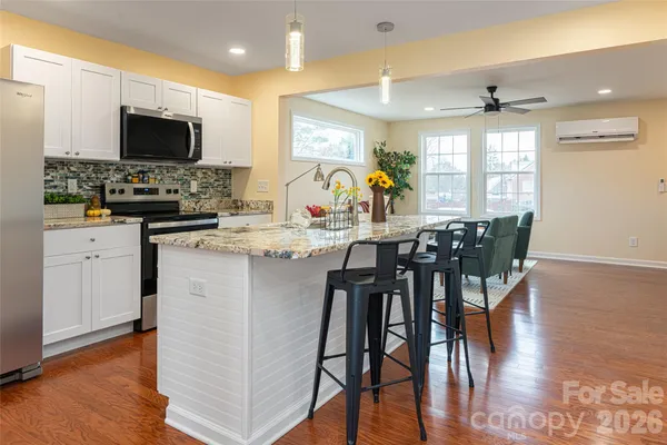 a view of a dining room with furniture window and wooden floor