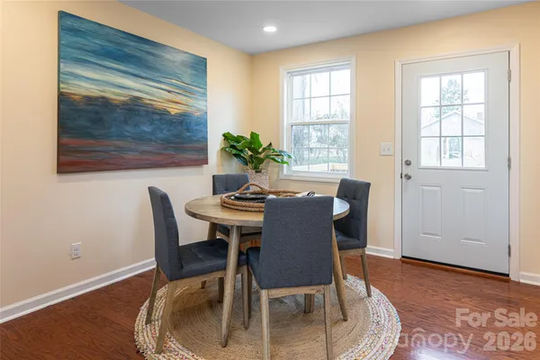 a dining room with furniture and window