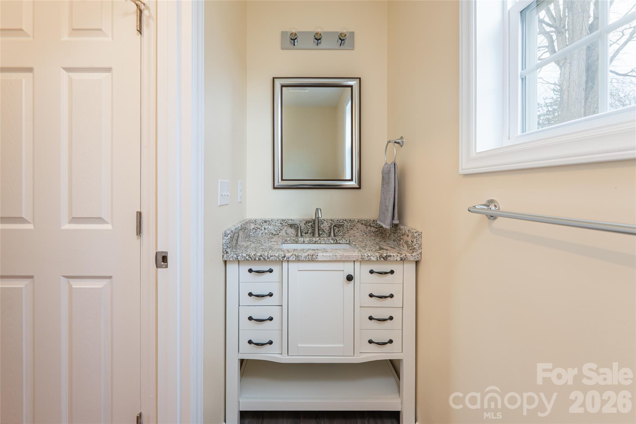 622 North Main Street Canton, NC 28716 - Photo 19 of 36 a bathroom with a granite countertop sink vanity and mirror