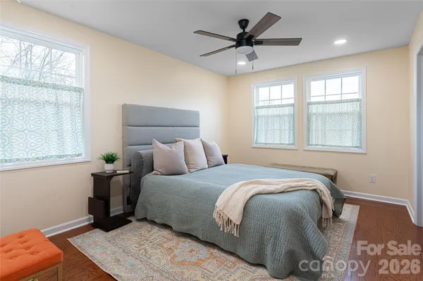 a bedroom with a large bed and a window
