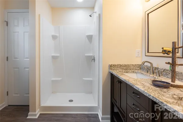 a bathroom with a granite countertop sink and a mirror