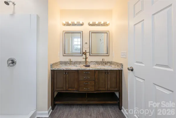 a bathroom with a granite countertop sink a mirror and a vanity