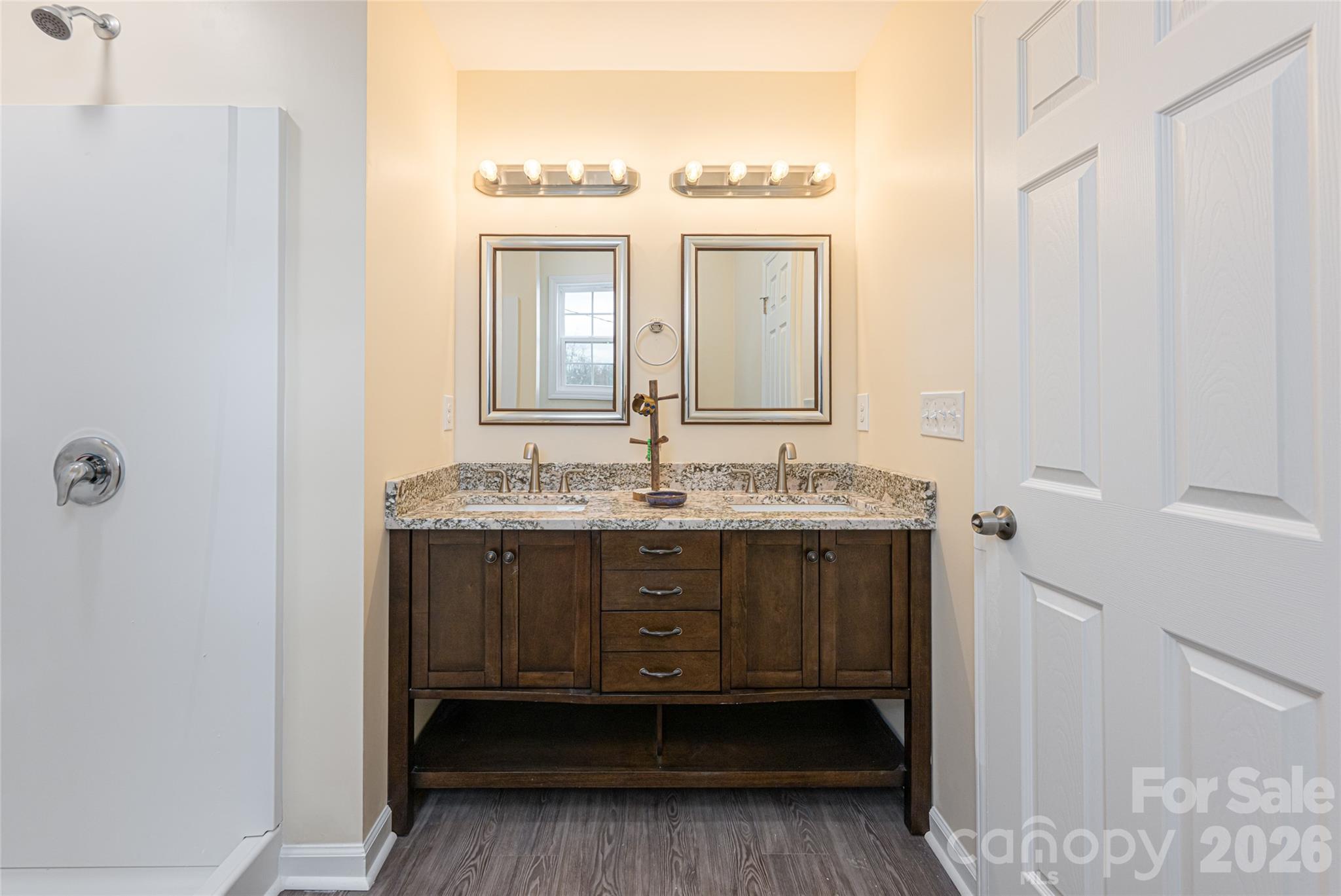 622 North Main Street Canton, NC 28716 - Photo 25 of 36 a bathroom with a granite countertop sink a mirror and a vanity