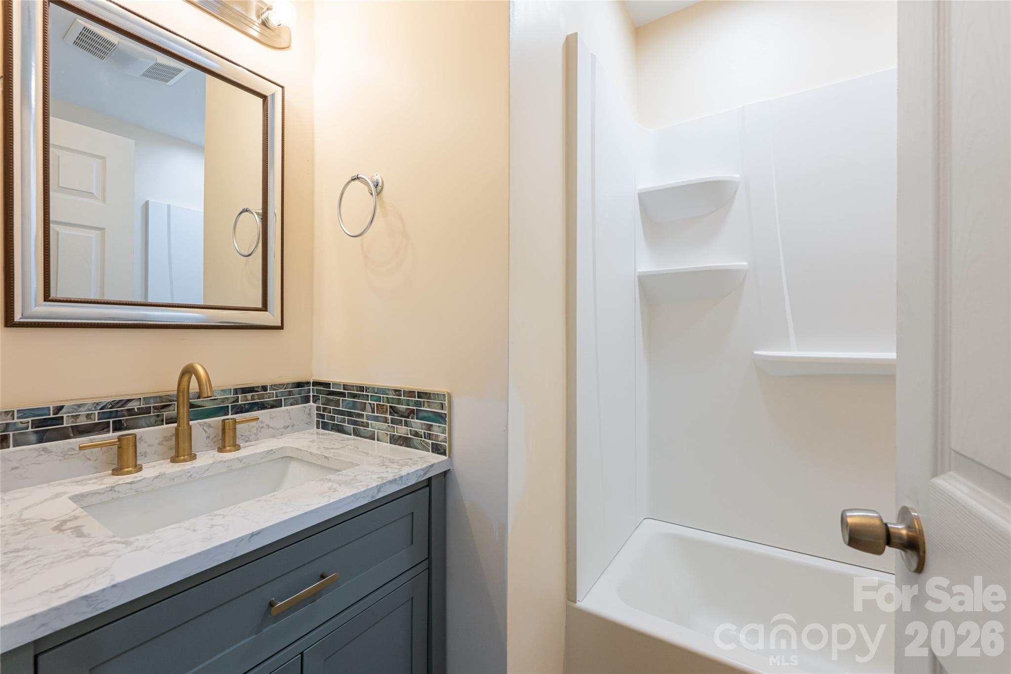 622 North Main Street Canton, NC 28716 - Photo 29 of 36 a bathroom with a sink and a mirror