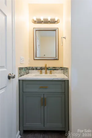 a bathroom with a granite countertop sink a mirror and a