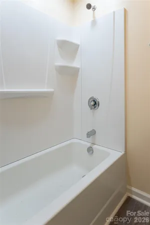 a white bath tub and shower