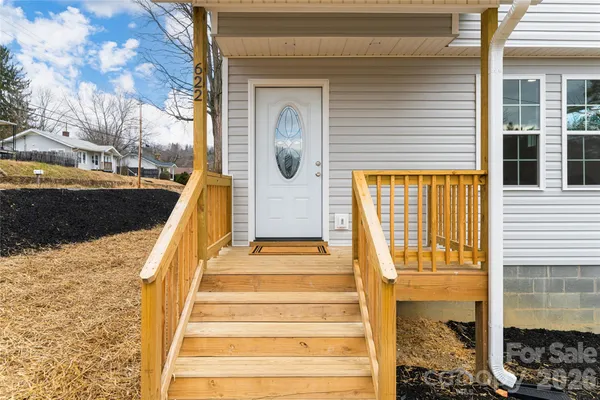 a view of a balcony with wooden floor and fence