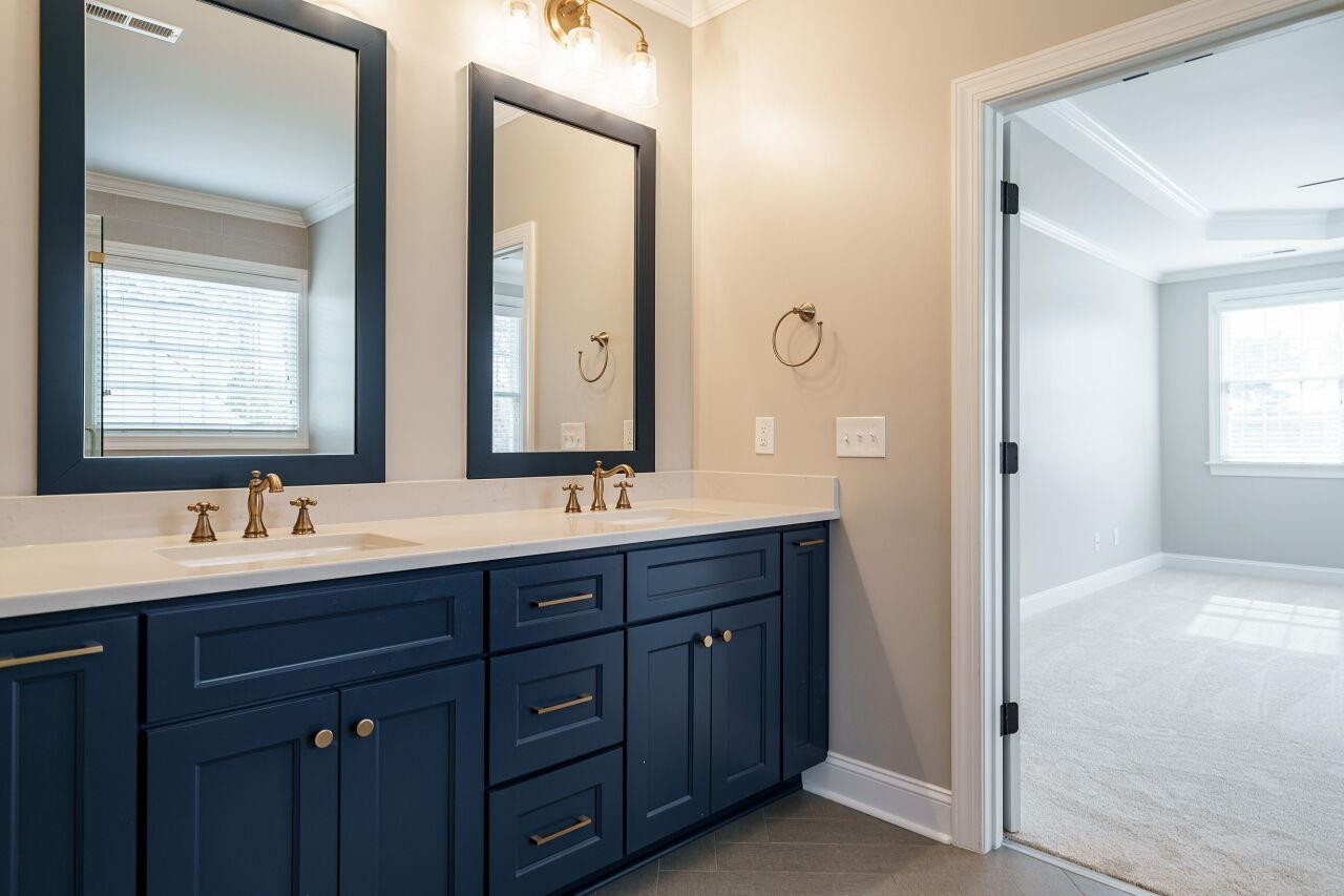 5327 Landguard Drive Raleigh, NC 27613 - Photo 25 of 45 Renovated, gorgeous owner's spa! Dual vanities, herringbone patterned floor tile, glass enclosed shower and water closet! Owner's Suite