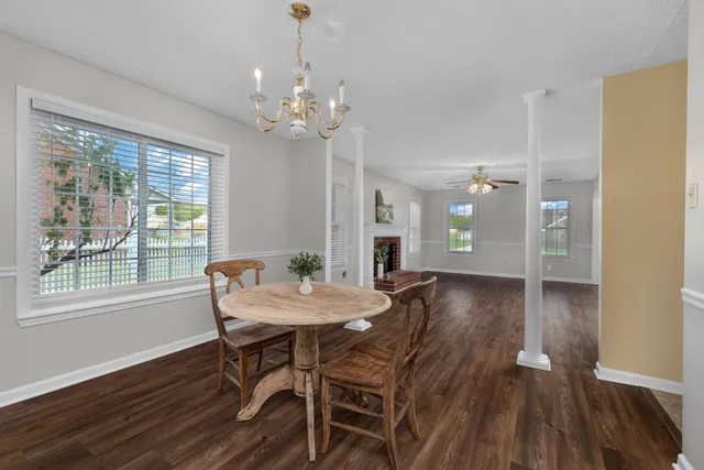 a view of a dining room with furniture wooden floor and chandelier