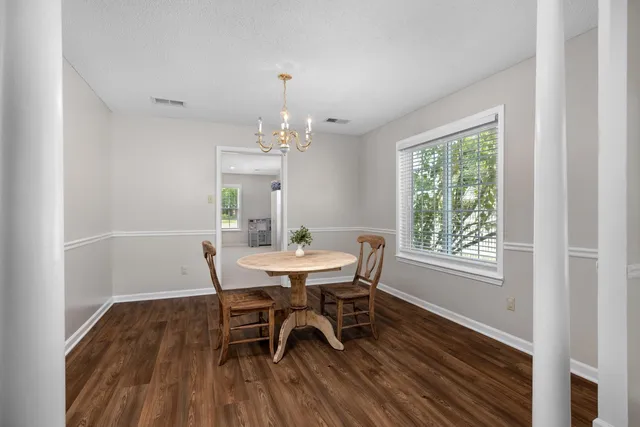 a view of a dining room with furniture and wooden floor