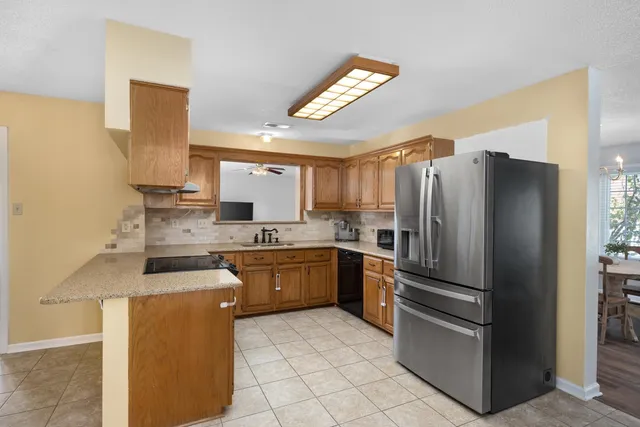 a kitchen with a refrigerator sink and stove