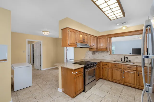 a kitchen with a sink stove and cabinets