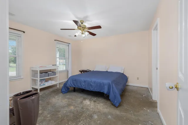 a living room with a bed furniture and a window