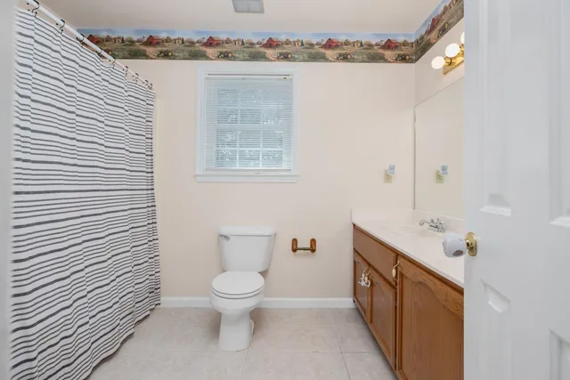 a bathroom with a toilet sink and shower