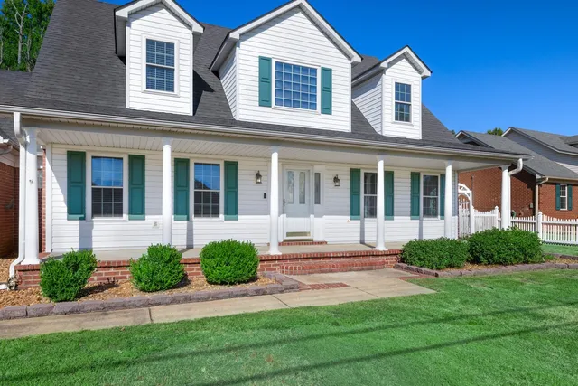 a front view of a house with garden and porch