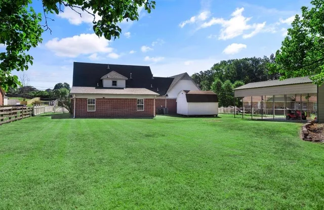 a front view of house with a garden and patio