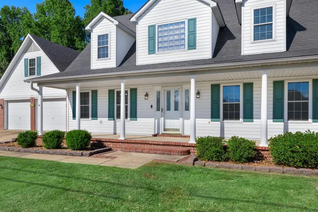 a front view of a house with a yard and glass windows