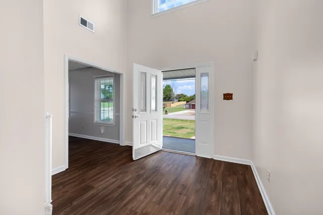 an empty room with a hardwood and wooden floor
