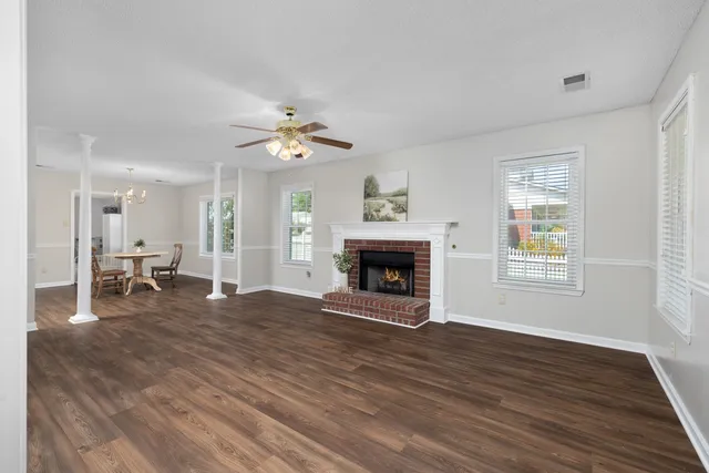 a view of an empty room with a fireplace and a window