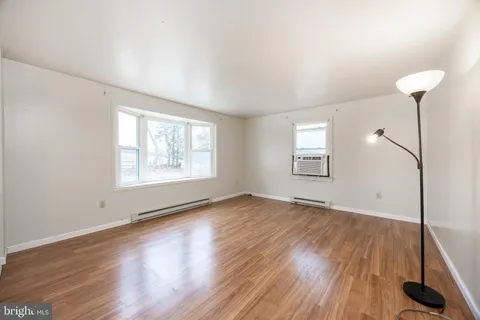 a dining room with furniture a chandelier and wooden floor