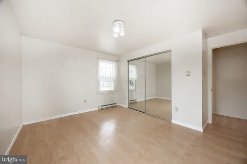 an empty room with windows and fireplace