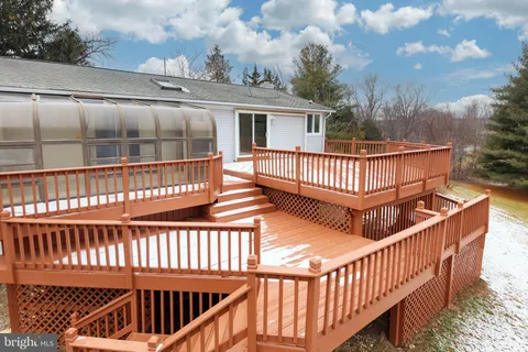 a view of a house with a wooden fence