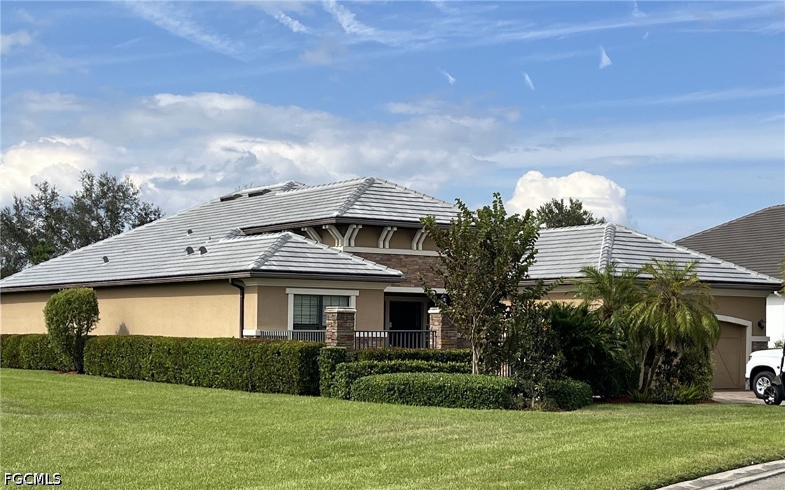 3341 Chestnut Grove Drive Alva, FL 33920 - Photo 1 of 44 a front view of a house with garden