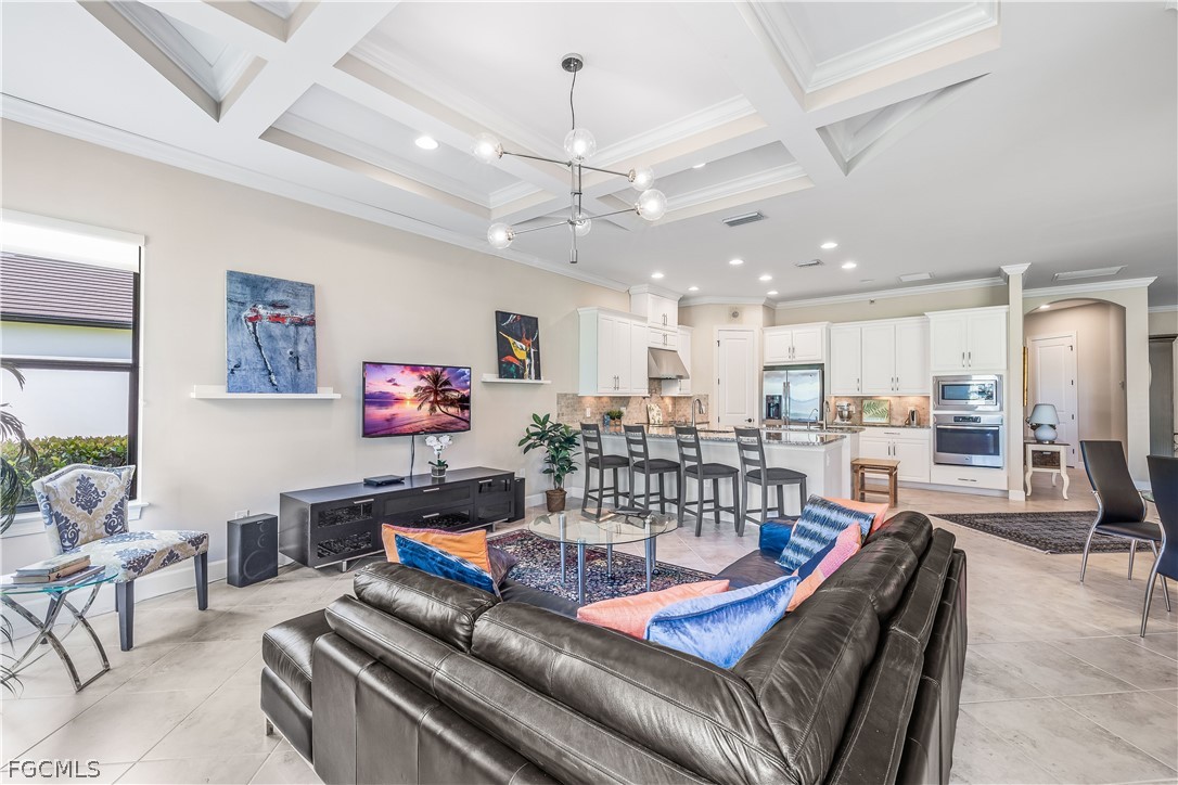 3341 Chestnut Grove Drive Alva, FL 33920 - Photo 14 of 44 a living room with furniture kitchen view and a chandelier