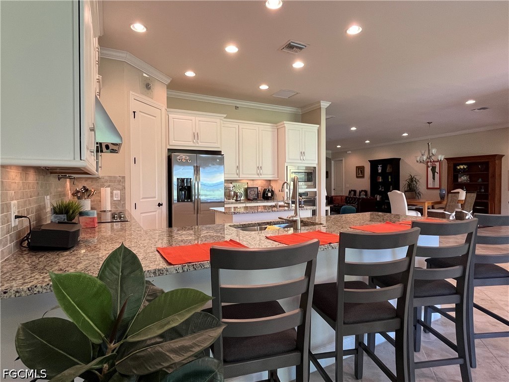 3341 Chestnut Grove Drive Alva, FL 33920 - Photo 15 of 44 a dining room with furniture and a view of kitchen