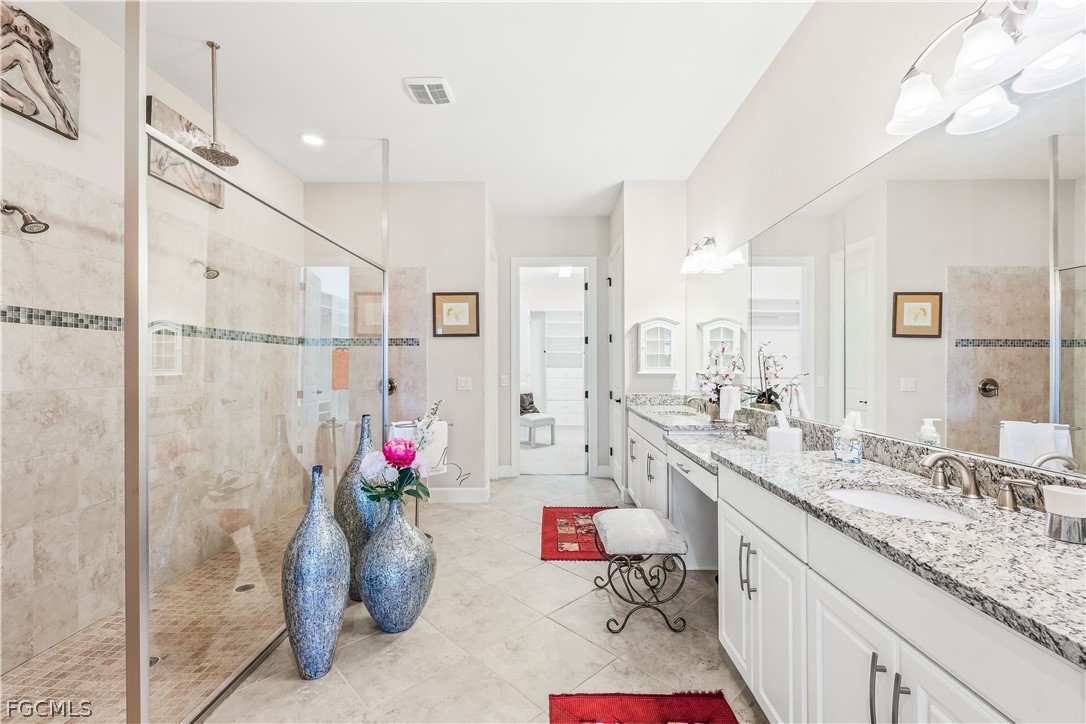 3341 Chestnut Grove Drive Alva, FL 33920 - Photo 19 of 44 a bathroom with a granite countertop sink a toilet and a shower