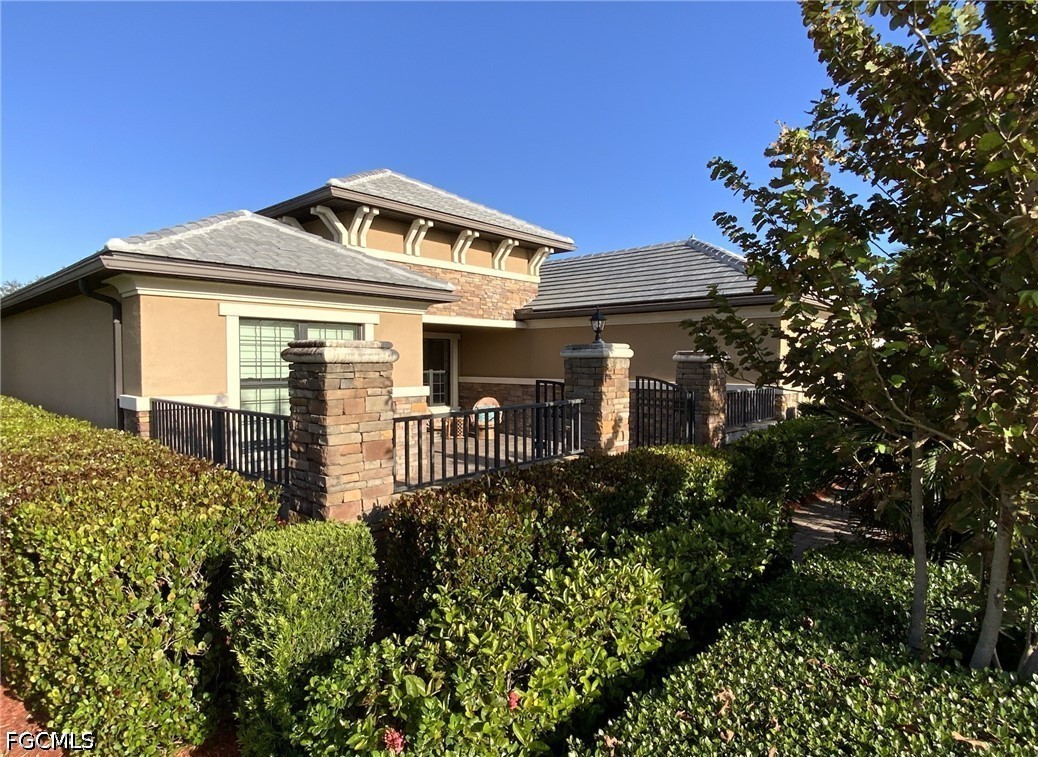 3341 Chestnut Grove Drive Alva, FL 33920 - Photo 2 of 44 a front view of a house with a garden