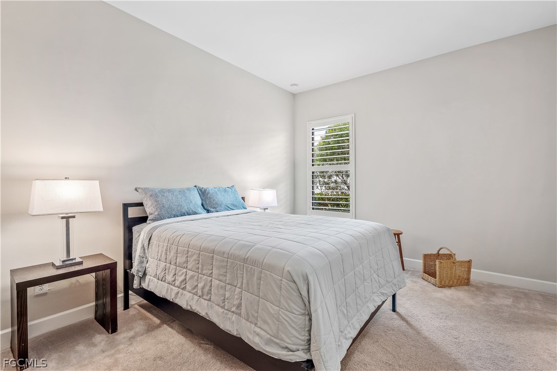 3341 Chestnut Grove Drive Alva, FL 33920 - Photo 21 of 44 a bedroom with a bed and a lamp