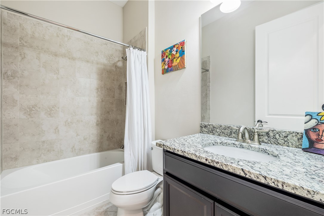 3341 Chestnut Grove Drive Alva, FL 33920 - Photo 24 of 44 a bathroom with a granite countertop sink a toilet and a bathtub