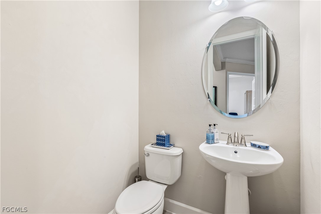 3341 Chestnut Grove Drive Alva, FL 33920 - Photo 28 of 44 a bathroom with a toilet sink and mirror