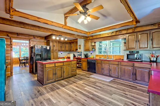 a room with lots of wooden furniture and floor to ceiling windows