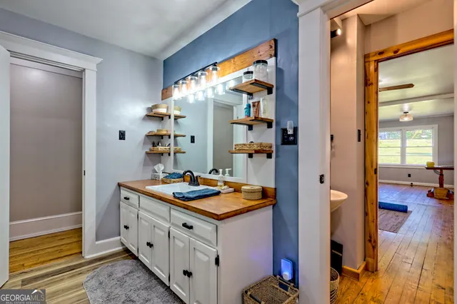 a view of a field with a lush green forest