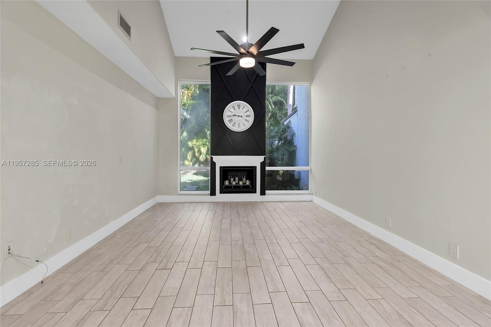 6768 Canary Palm Circle Boca Raton, FL 33433 - Photo 11 of 39 a view of an empty room with a window and wooden floor